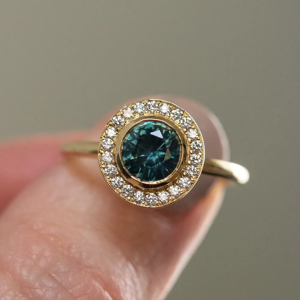 1.22ct Deep Teal Montana Sapphire With Bezel Set Diamond Halo In 18k Yellow Gold