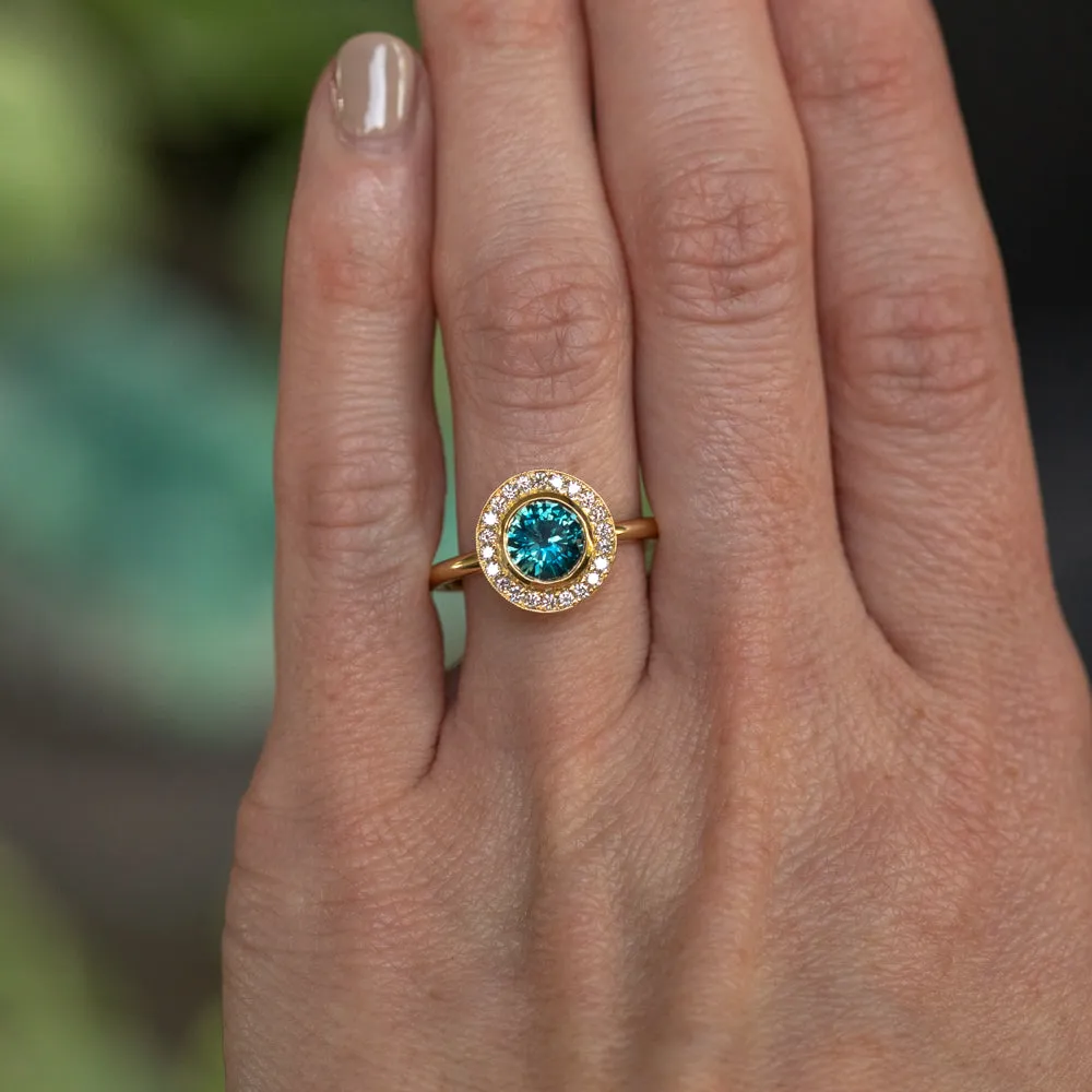 1.22ct Deep Teal Montana Sapphire With Bezel Set Diamond Halo In 18k Yellow Gold