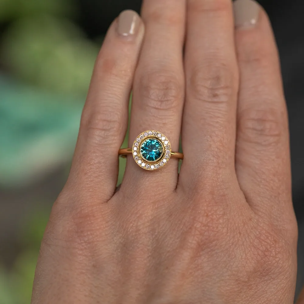 1.22ct Deep Teal Montana Sapphire With Bezel Set Diamond Halo In 18k Yellow Gold