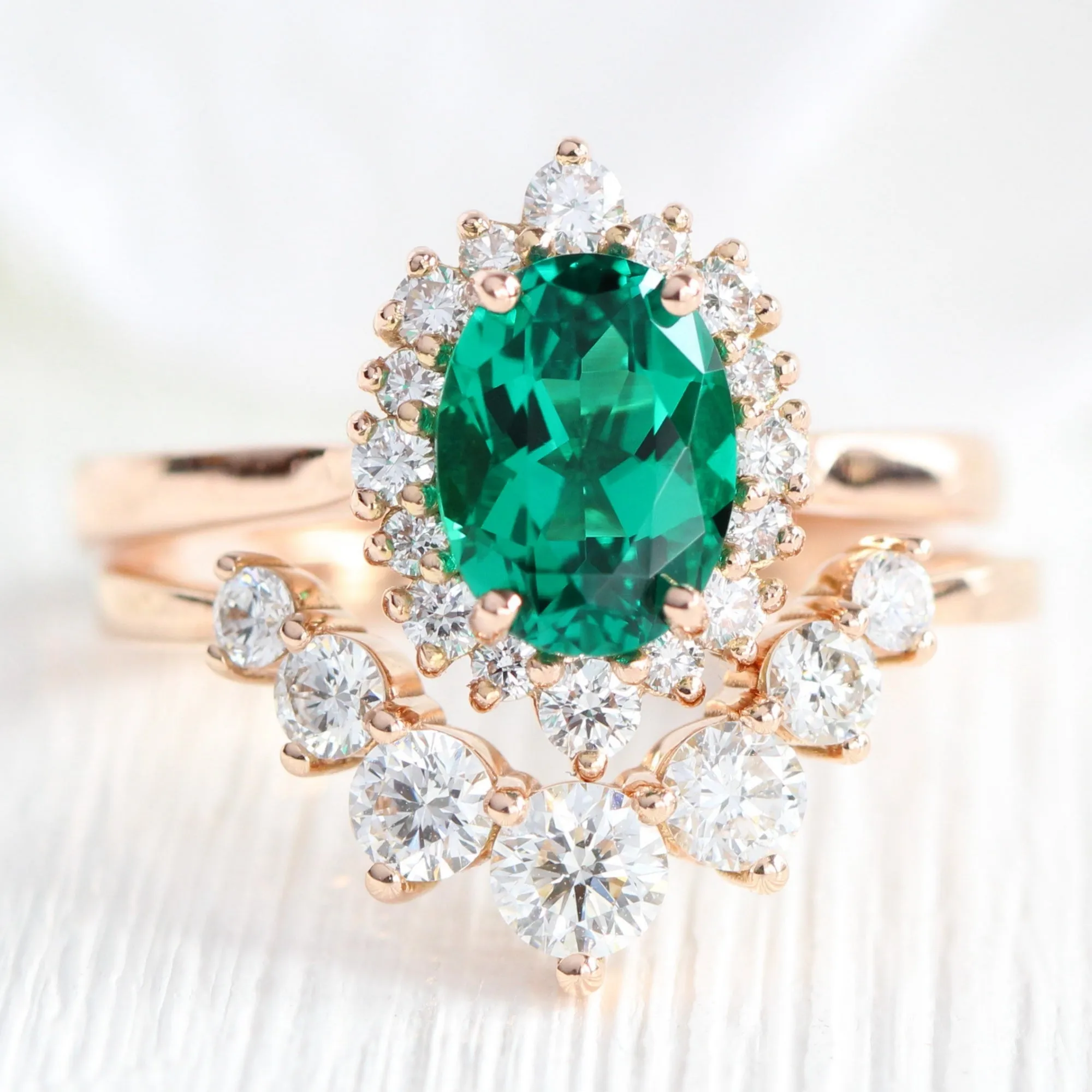 Oval Emerald Engagement Ring in Tiara Halo Diamond Tapered Band