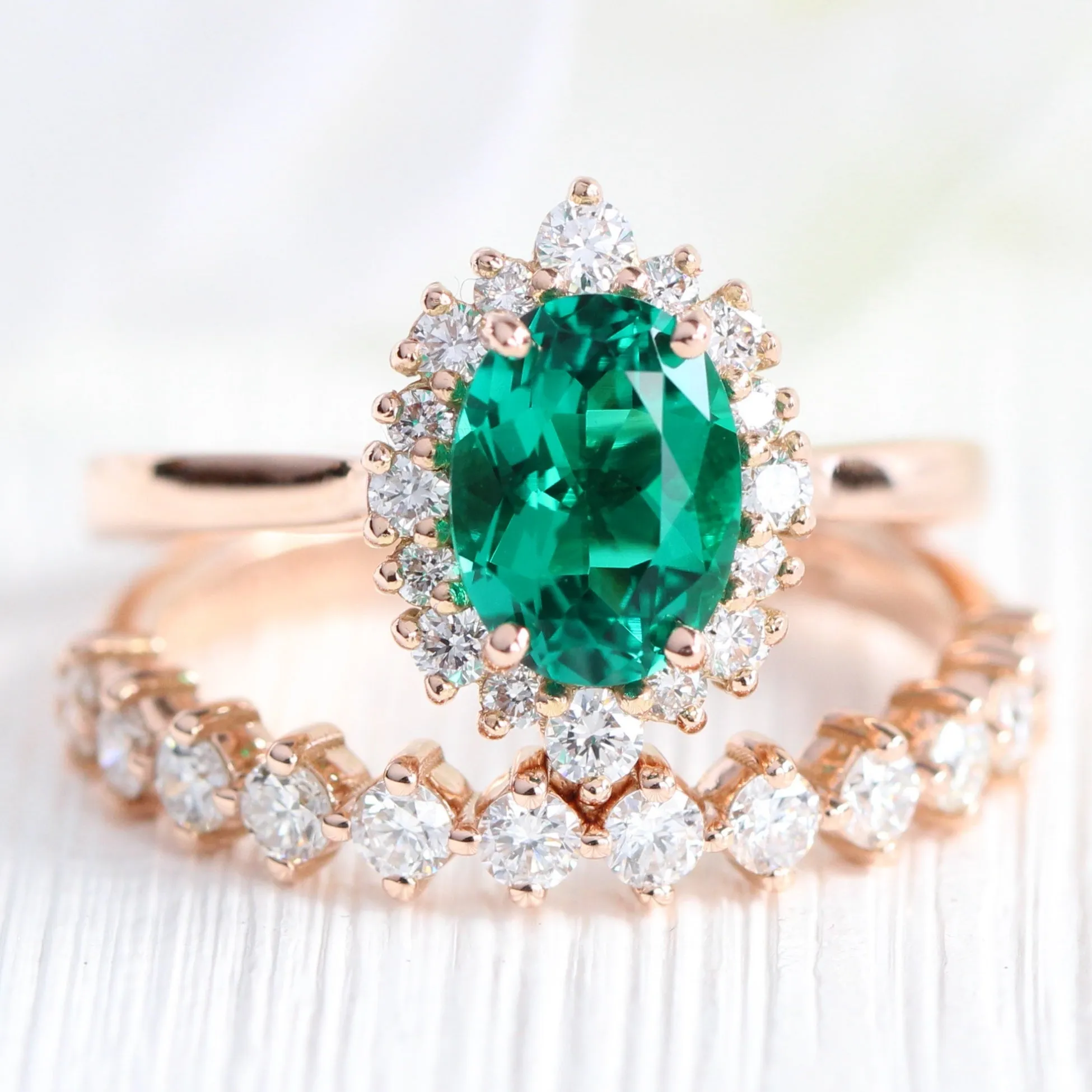 Oval Emerald Engagement Ring in Tiara Halo Diamond Tapered Band